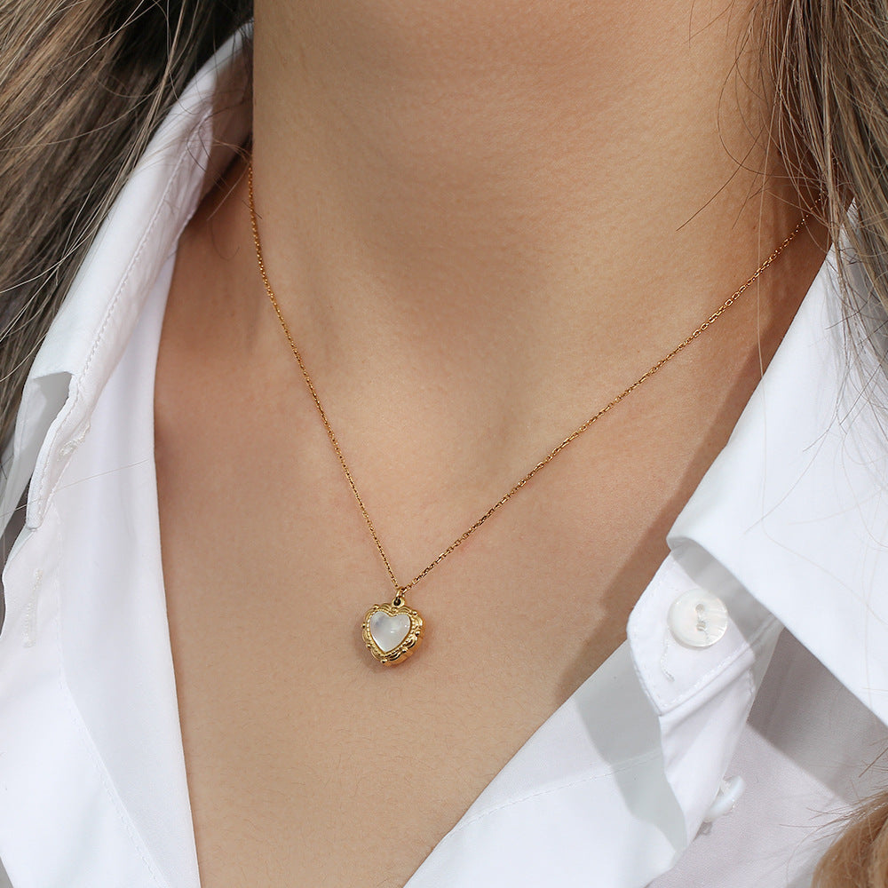 Shell heart necklace worn with a white shirt